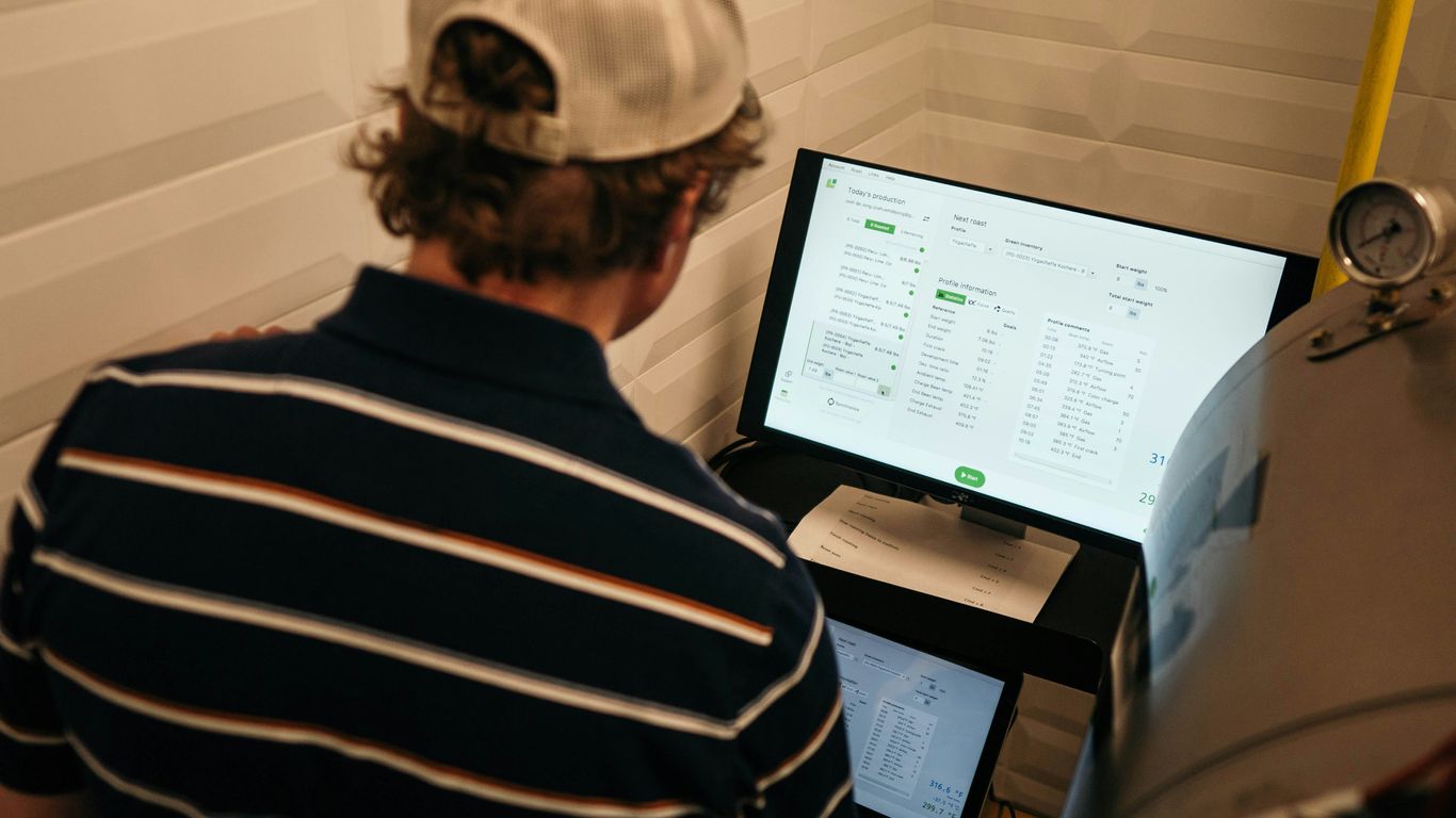 A professional examining data on a bright computer screen